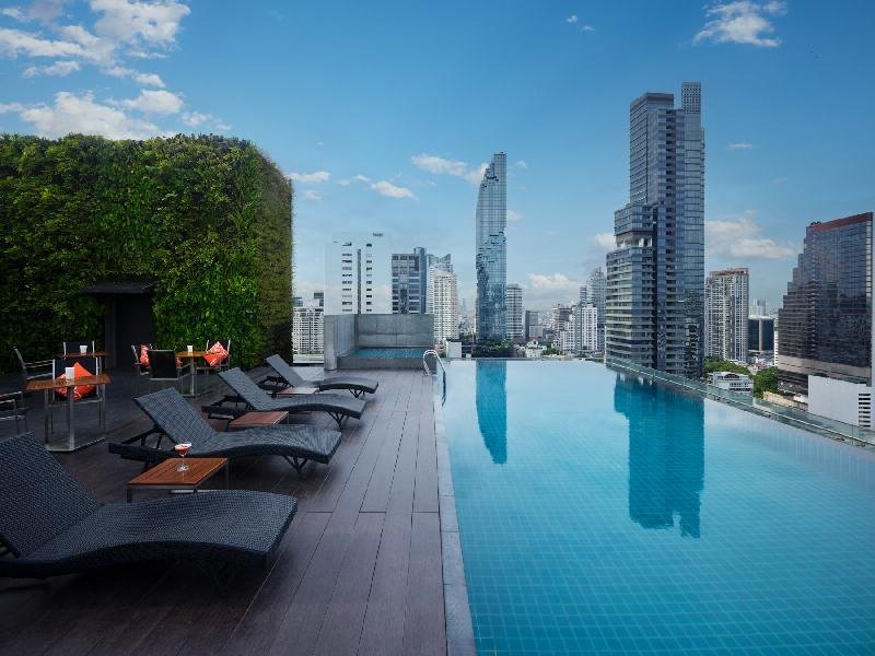 Amara Bangkok Hotel rooftop pool and city skyline