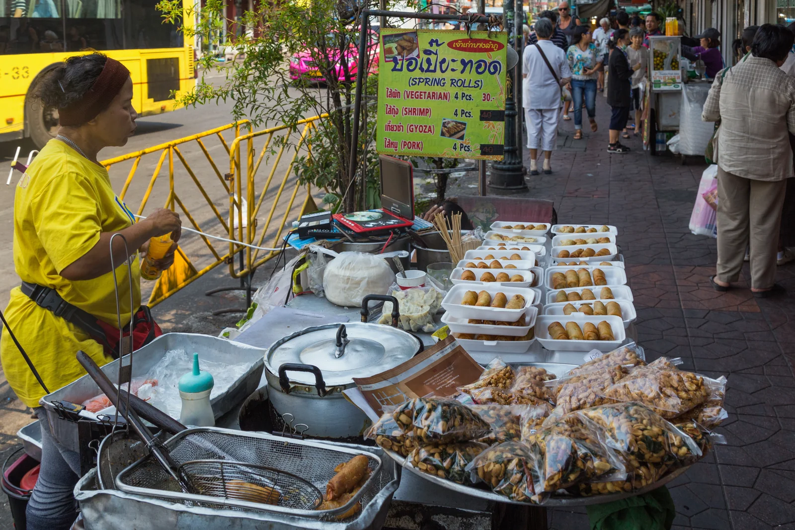 A street food vendor preparing food at a Bangkok market