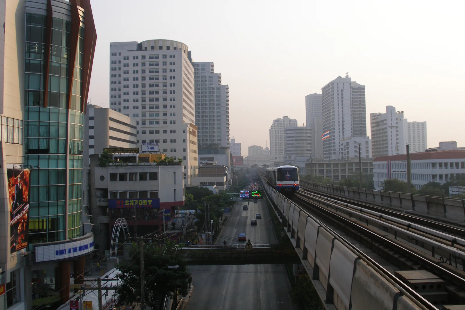 BTS Skytrain crossing the Bangkok skyline at sunset