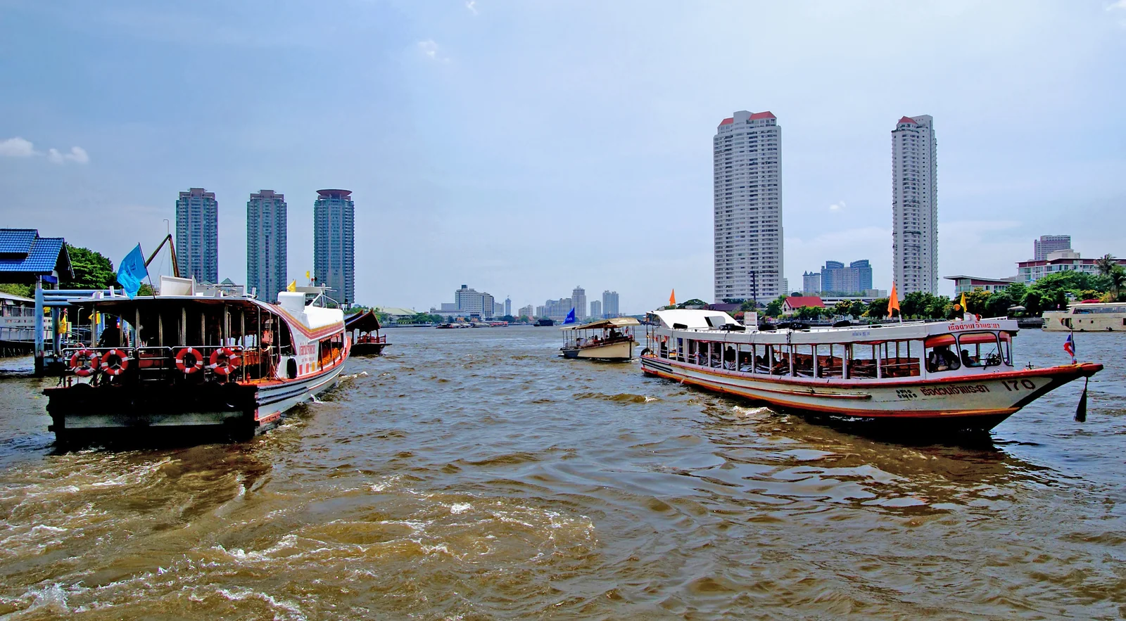 Chao Phraya River water transport with public ferry near Sathorn Pier Bangkok