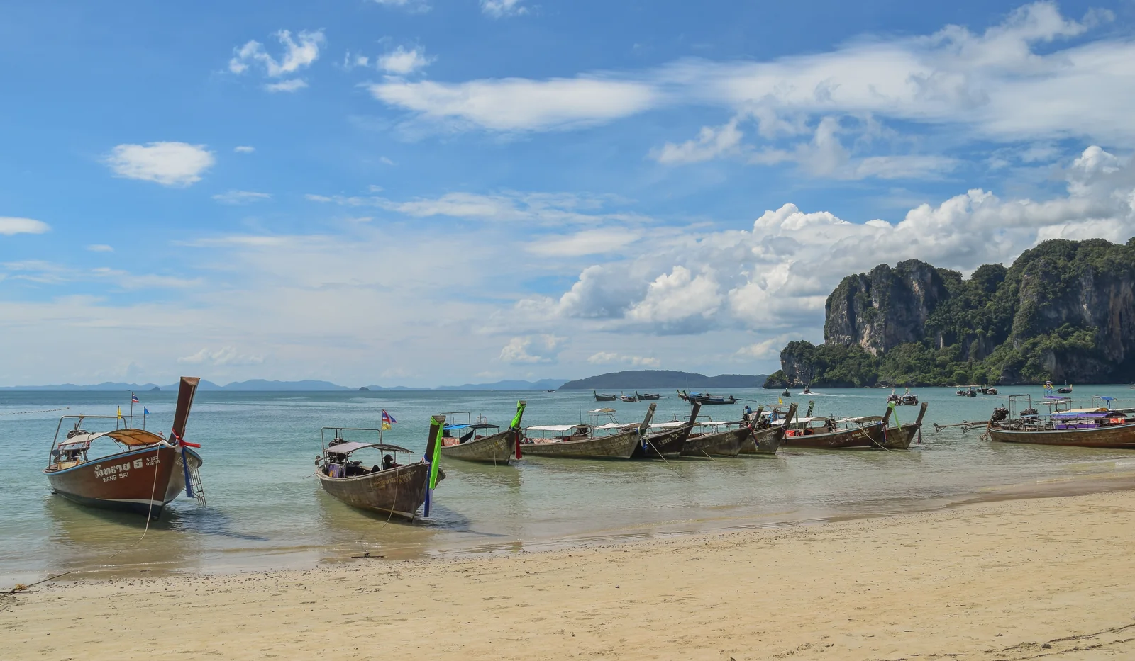 Railay Beach with limestone cliffs and longtail boats