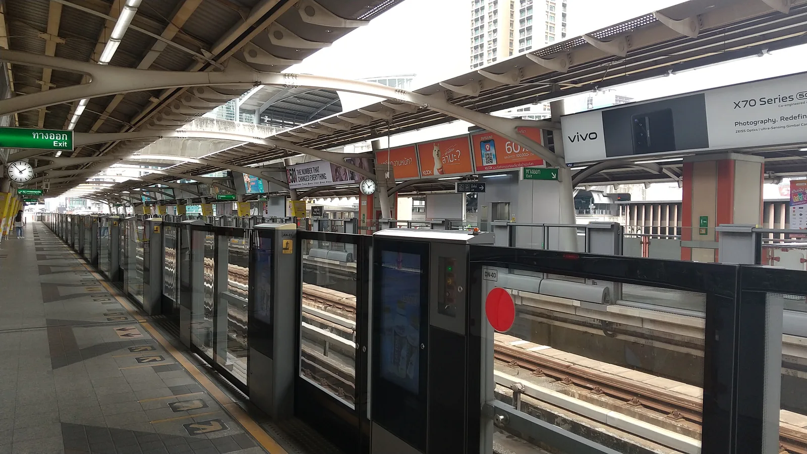 Phaya Thai BTS Sukhumvit Line station platform with arriving train, Bangkok