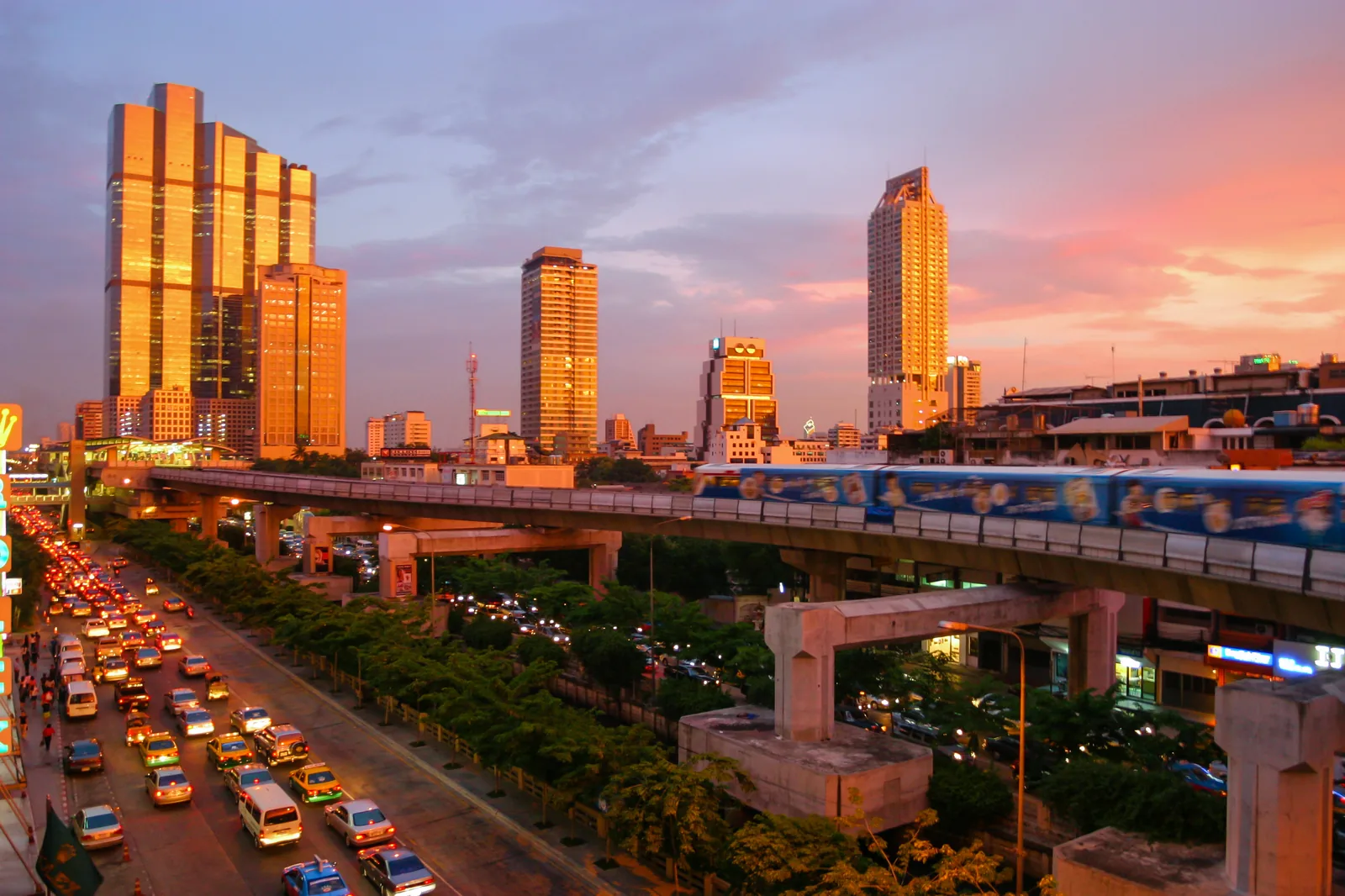 Bangkok BTS Skytrain elevated track and train silhouetted at sunset over Sukhumvit