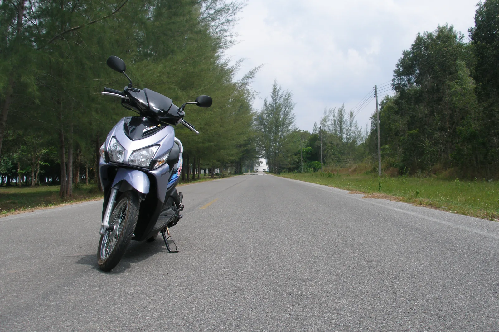Honda Click 125cc automatic scooter parked on a Thai street, the standard Phuket rental model