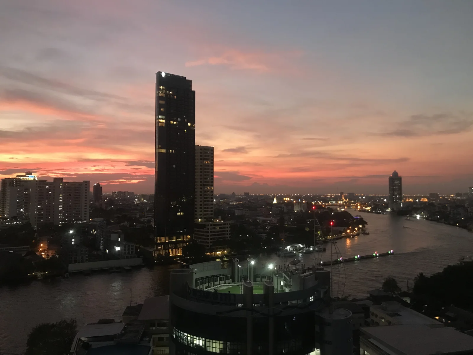 Sunset over the Chao Phraya River from Talat Noi, the Chinatown lane where one-star Potong sits