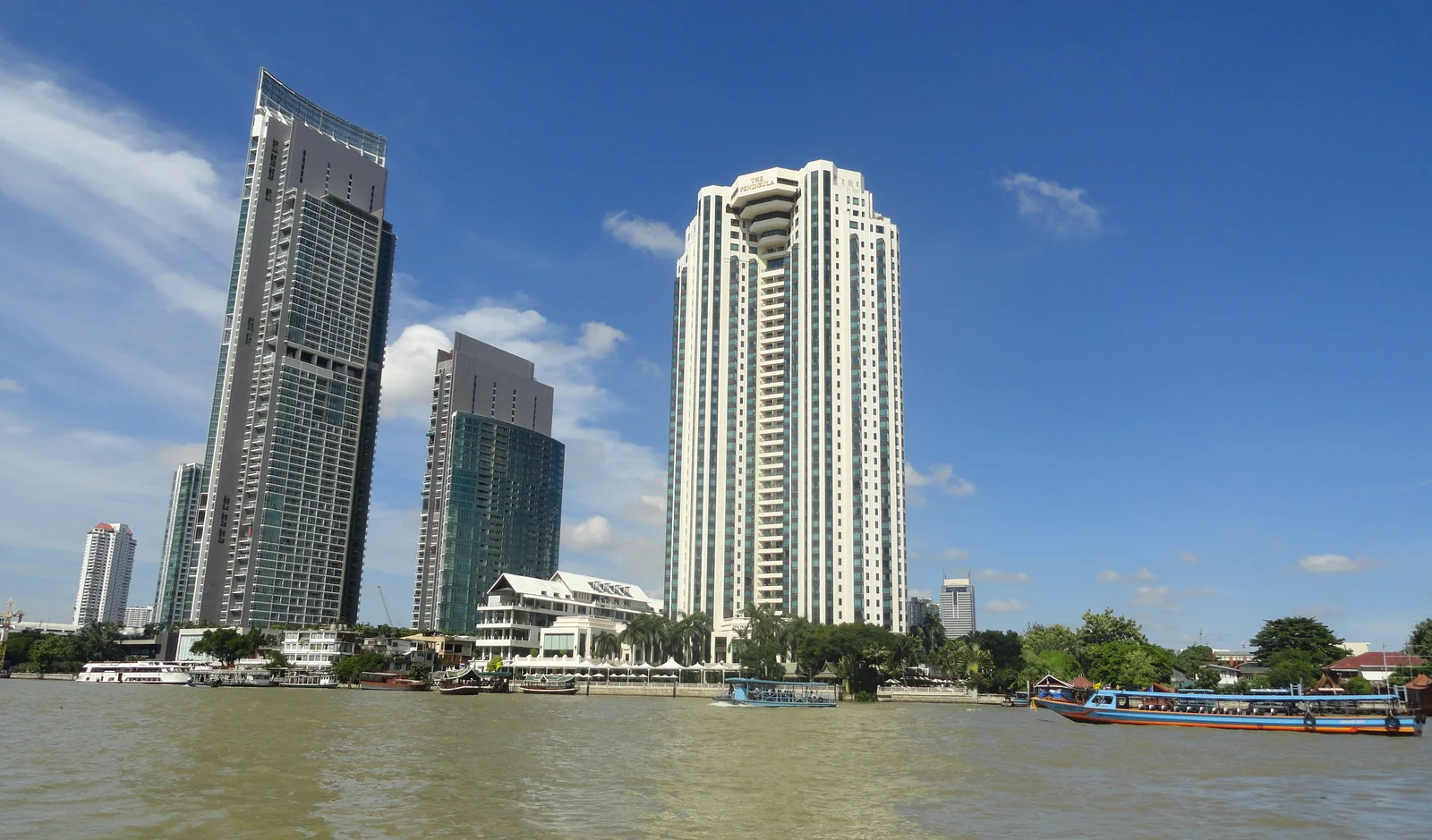 The Peninsula Bangkok W-shaped tower seen from the Chao Phraya River