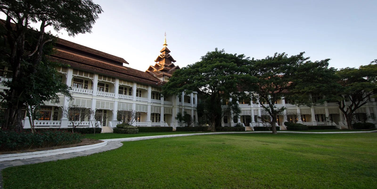 Wide view of the Dhara Dhevi Chiang Mai grounds with Lanna structures and gardens