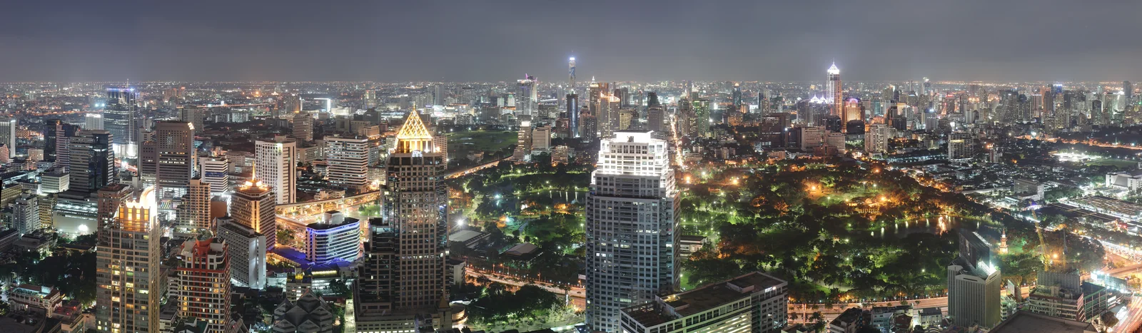 Bangkok skyline at night looking across Lumpini Park toward the Sukhumvit and Silom towers