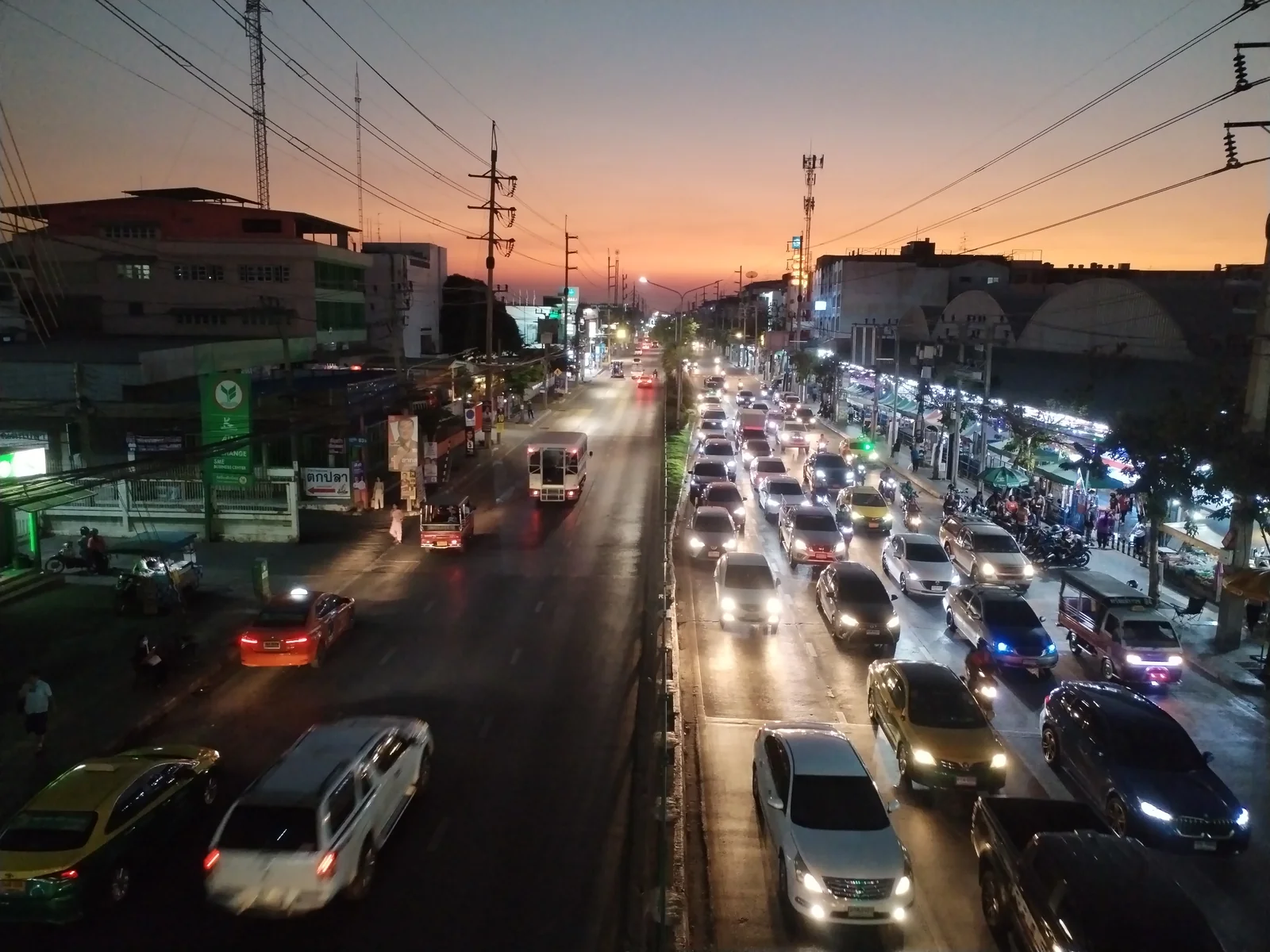 Bang Rak street life with shophouses and food vendors near State Tower in central Bangkok