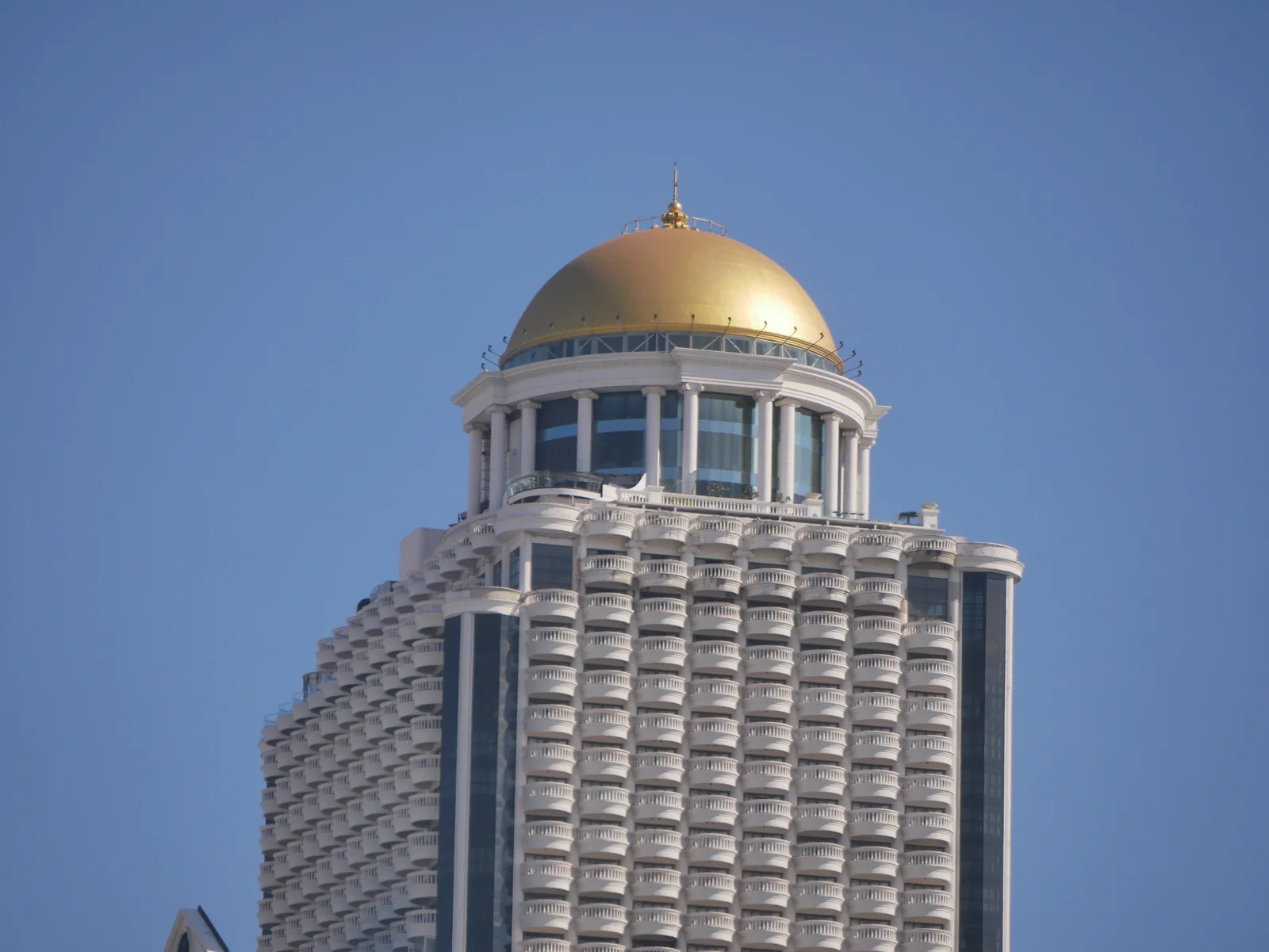State Tower on Silom seen across the Chao Phraya at dusk, the tower housing lebua at State Tower